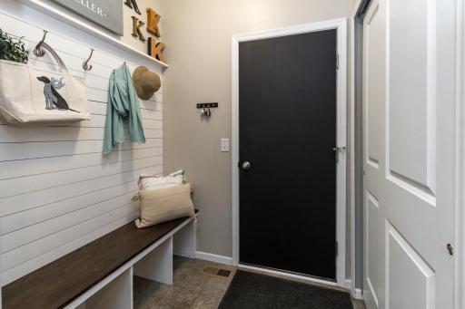 The mud room, right off the garage, couldn't be more convenient, with built-in bench, mounted hooks, and deep closets..