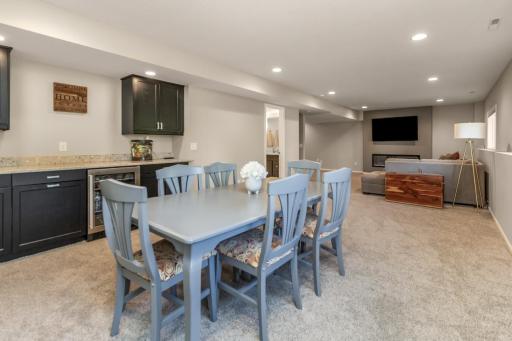 The dry bar with built-in beverage fridge is perfect for movie night or game day.