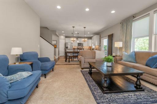 Recessed lighting and soaring ceilings offer an elevated feel to this living room.