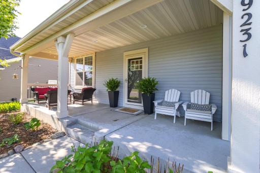 The outdoor spaces, like this shaded front porch, really make this home a standout.