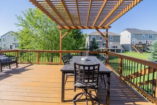 The massive deck is crowned by a beautiful pergola that sets the stage for unforgettable summer gatherings.