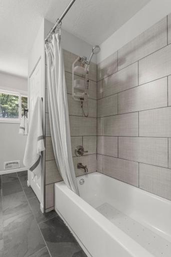 Main Level Full Bath with Custom Tile Work Surrounding the Tub