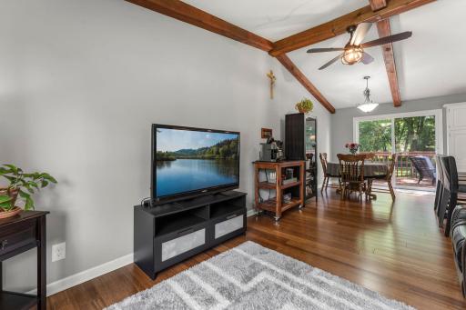 Living Room Open to the Dining Area with Durable Laminate Flooring Throughout the Main Level