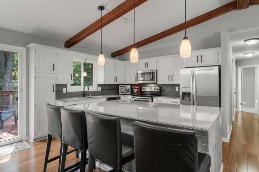 Oversized Granite Kitchen Island Allows for Additional Dining Space