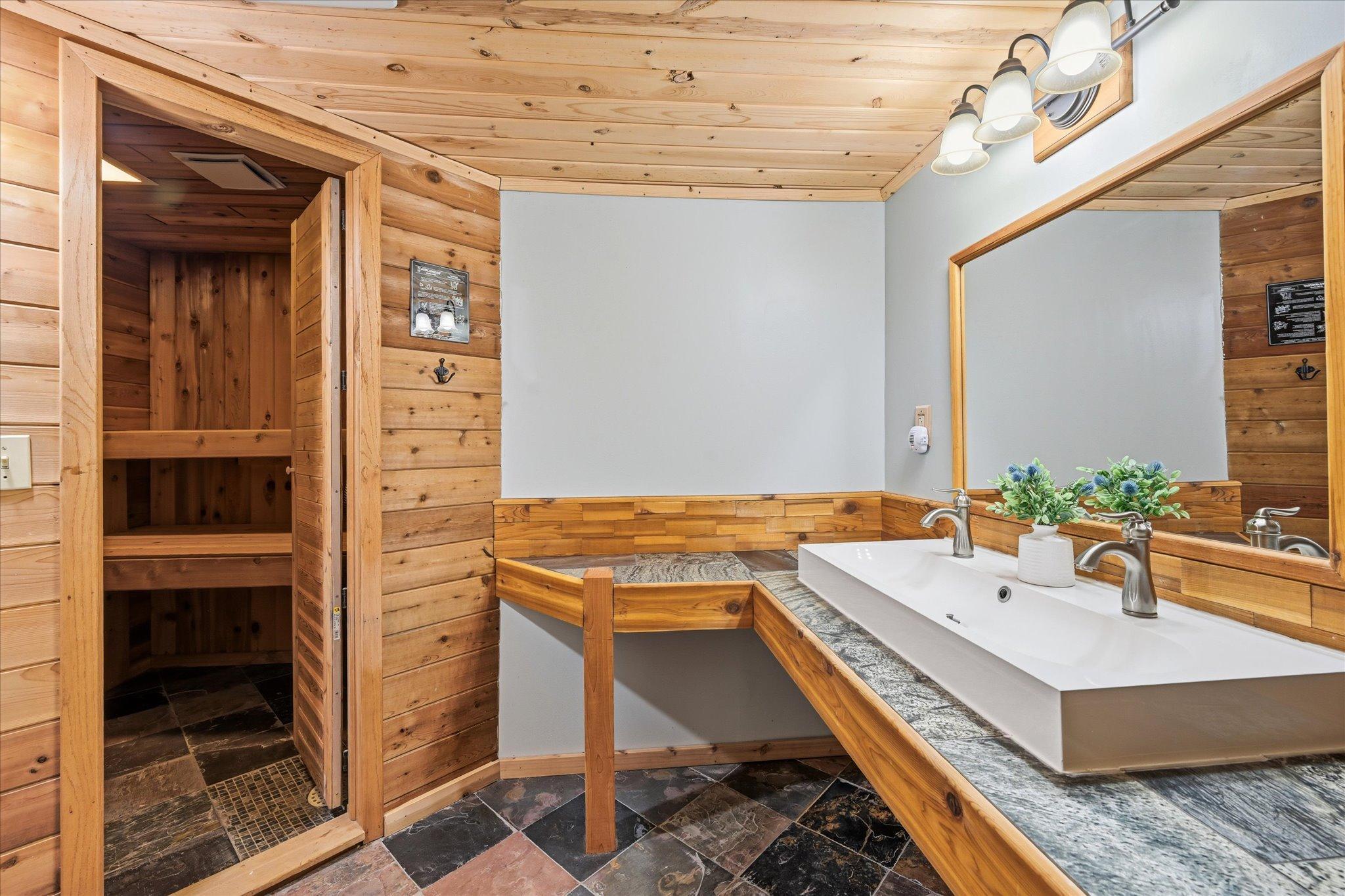 Bathroom features a sauna and tiled walk in shower.