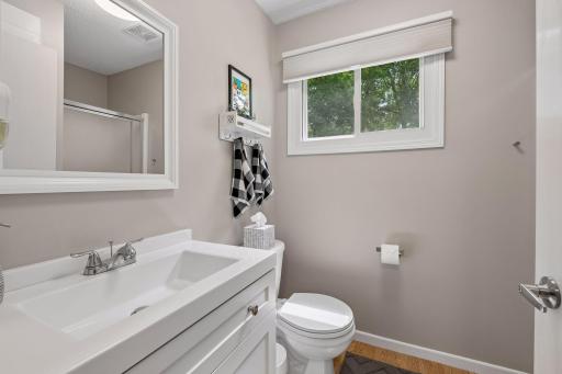 The updated main-floor bath features a stylish new vanity and vanity top, creating a fresh and modern feel.