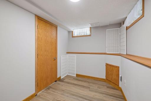 A flexible lower-level room offers the perfect space for a home office, craft room, exercise area, study space, or additional storage.