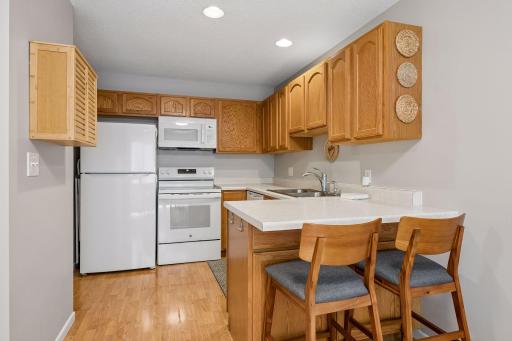 Thoughtfully designed with new appliances, plentiful cabinet space, and a convenient breakfast bar, this kitchen offers both functionality and comfort.