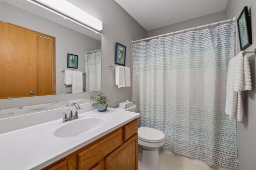 The upper-level full bath has been refreshed with a new vanity top, offering a clean and updated look. Conveniently located near the bedrooms.