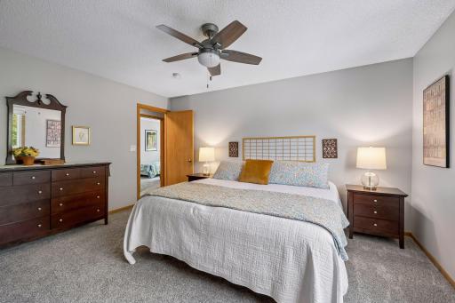 The large primary bedroom provides a relaxing escape with abundant natural light, ample closet space, and room for a king-size bed and additional furnishings