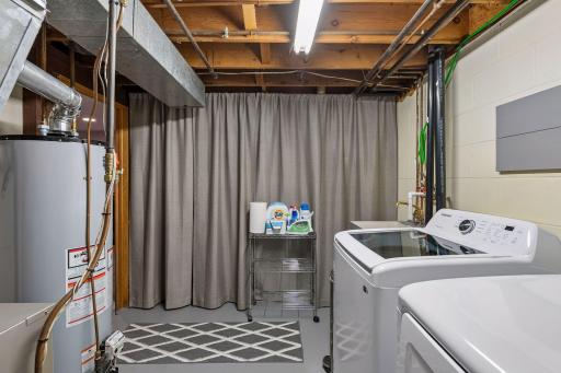 Thoughtfully designed for practicality, the utility room features a new washer and dryer, utility sink, and generous space for laundry, storage, and everyday convenience.