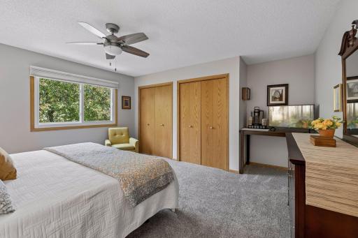 The generous layout easily accommodates a sitting area, workspace, or additional storage.