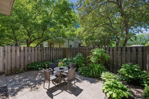 Step outside to your own private, fenced patio retreat surrounded by mature trees, lush landscaping, and colorful perennial gardens.