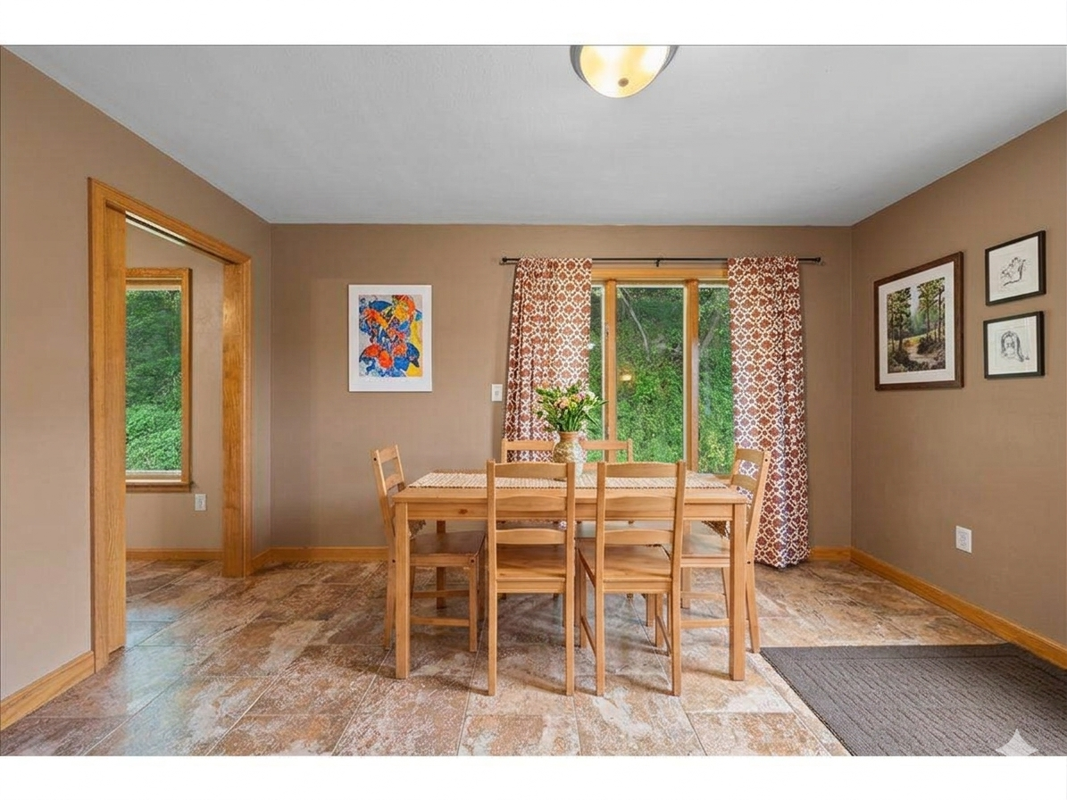Eat-in kitchen area with door to the laundry room (virtually staged)