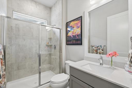 This main-level bathroom combines comfort, convenience, and modern design. Featuring a spacious walk-in shower, the space offers a clean, open feel with sleek finishes and easy accessibility. The shower is thoughtfully designed with quality fixtures.
