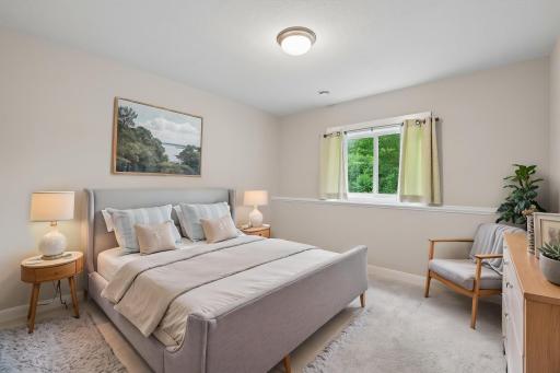 The lower-level bedroom offers a comfortable and private retreat, perfect for guests, family members, or extended living arrangements. Designed with functionality in mind, the space features a generous layout.