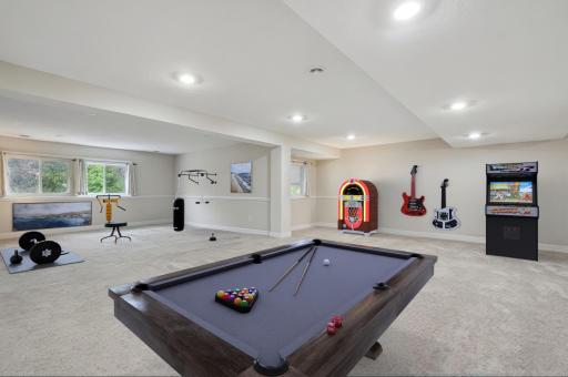 This expansive lower-level room has been thoughtfully virtually staged to showcase its full potential as a versatile and inviting living area. The generous open layout highlights the ample square footage, offering endless possibilities for use.