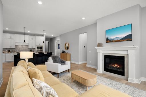 From the opposite side of the room, a large, comfortable sofa faces a wall mounted TV. Enjoy watching your favorite shows and movies.