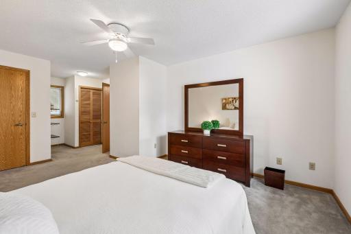 Large primary bedroom with laundry by bathroom.
