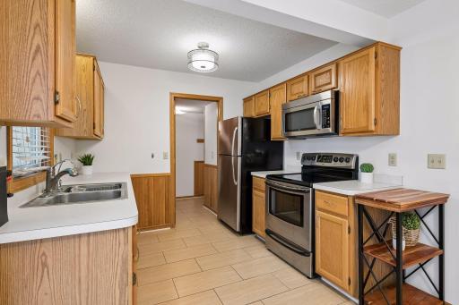 Hall off kitchen has access to garage, mechanical room and half bath.