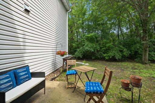 Sweet outdoor patio space with wooded backdrop.