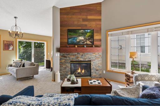 Stunning corner gas fireplace with stone and wood surround