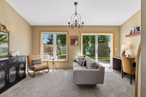 Large sunroom off the back of the home with sliding doors to patio