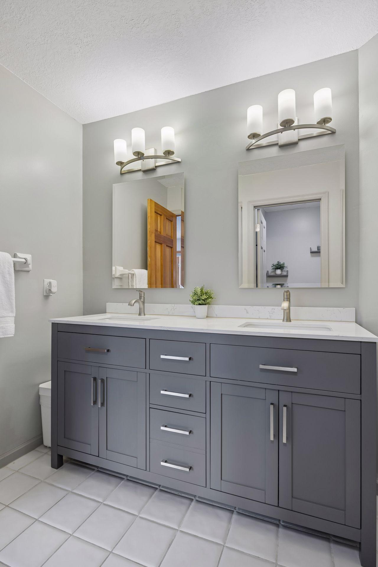 Spacious upper-level bathroom with separate sink area and private shower, tub, and toilet area—ideal for multiple people getting ready at once.