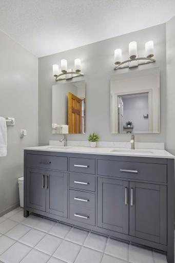 Spacious upper-level bathroom with separate sink area and private shower, tub, and toilet areaâideal for multiple people getting ready at once.