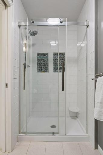 Beautifully updated primary shower with a clean, modern finish and spacious design.