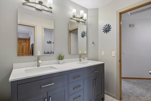 Conveniently located bathroom with access from the hallway and direct access to one of the upper-level bedrooms.