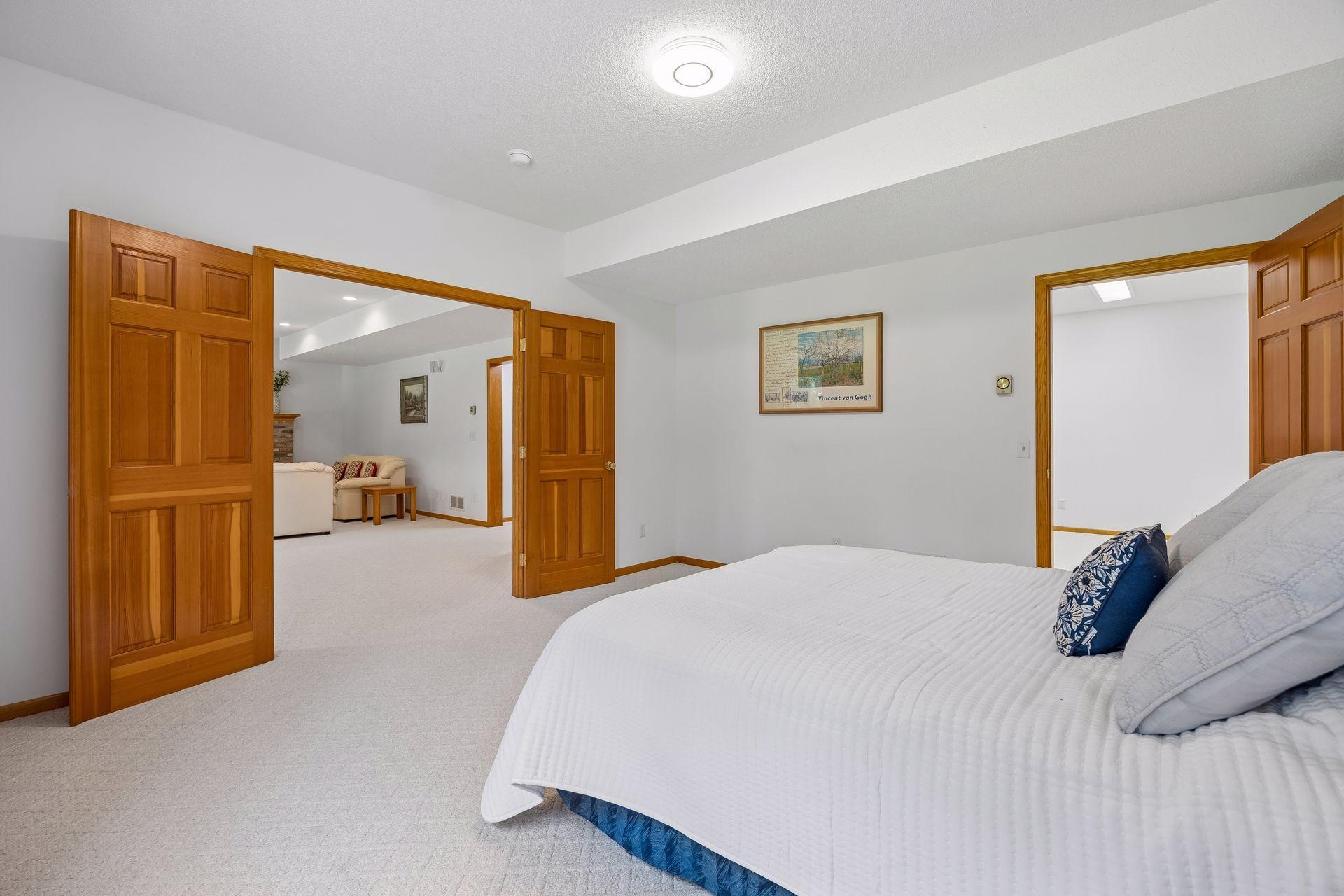 Spacious 5th bedroom in the lower level featuring high ceilings and a private setting.
