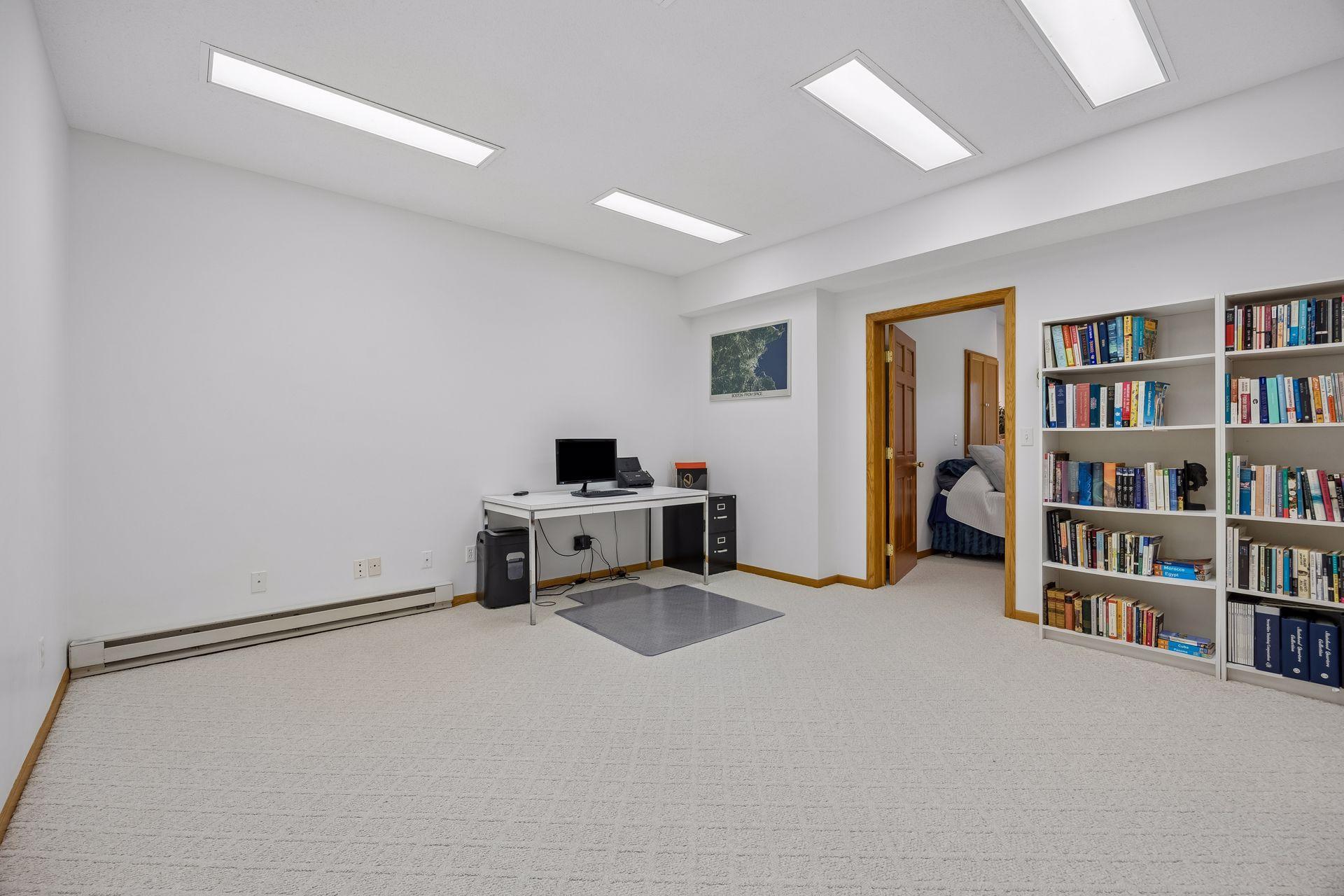 Spacious lower-level flex space offering endless possibilities for a home office, exercise room, hobby space, or additional living area.
