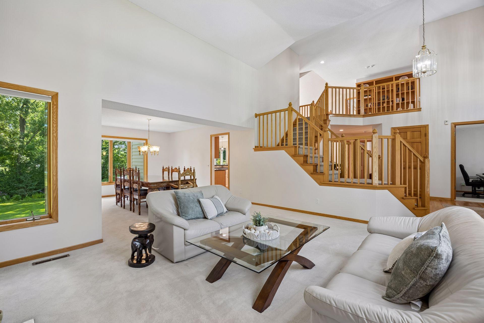 Spacious living and dining areas designed for comfortable living and entertaining, with soaring two-story ceilings in the living room creating an impressive sense of space.