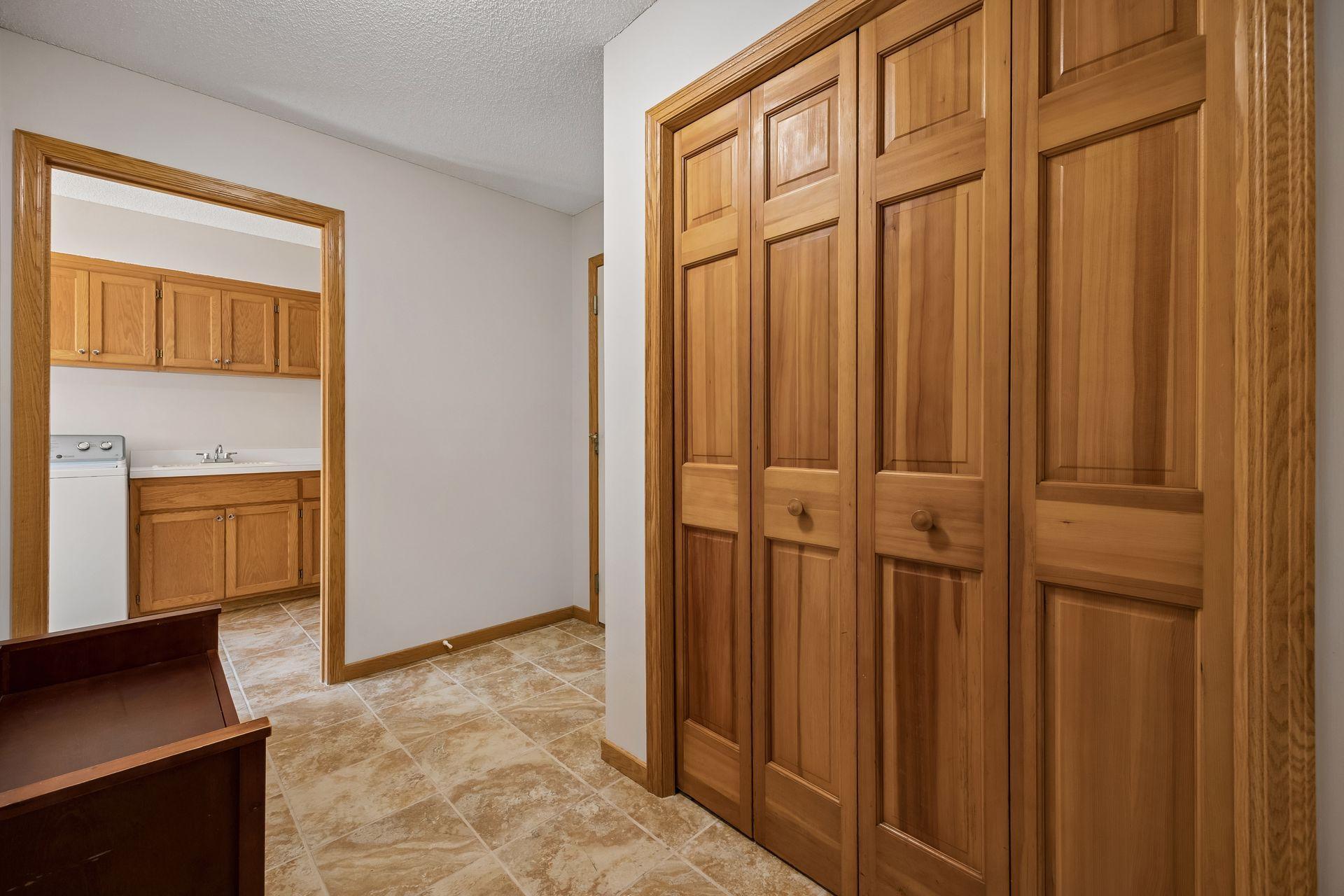 Spacious mudroom conveniently located off the garage featuring ample storage.