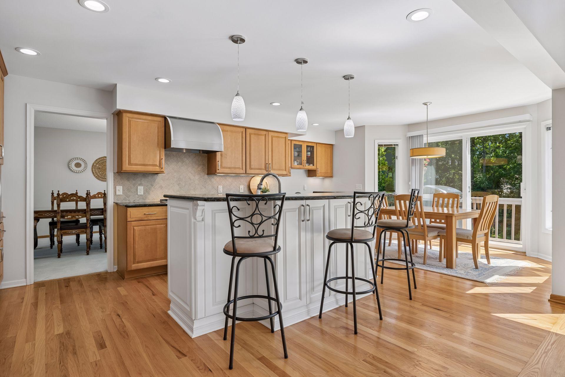 Open kitchen featuring stainless steel appliances, countertop seating, and an eat-in area. The seamless flow into the main living space creates an inviting layout for everyday living and entertaining.