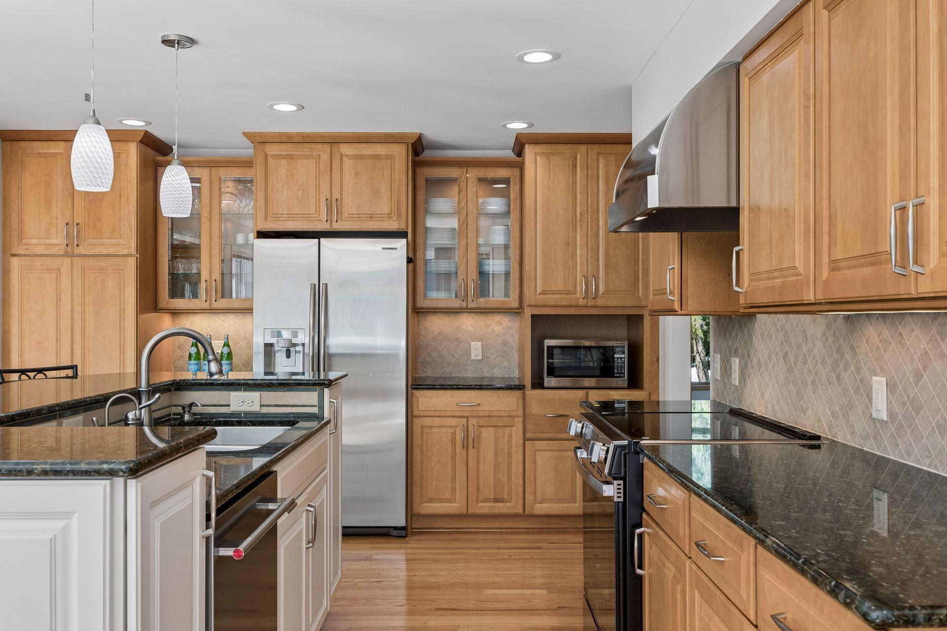 Kitchen features updated stainless steel appliances and a functional layout.