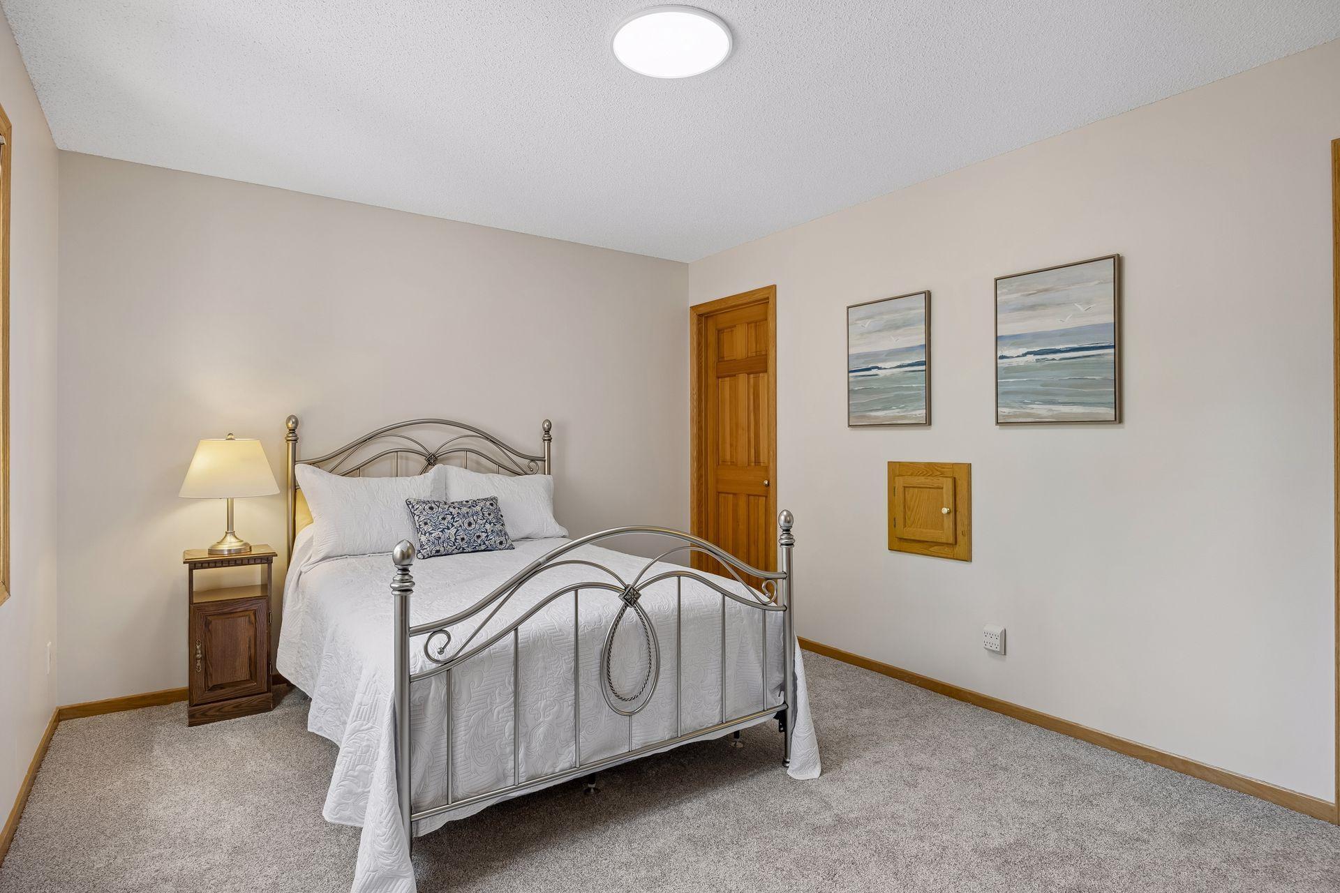 One of four spacious bedrooms on the upper level, featuring a private attached bathroom and a large walk-in closet for added comfort and convenience.