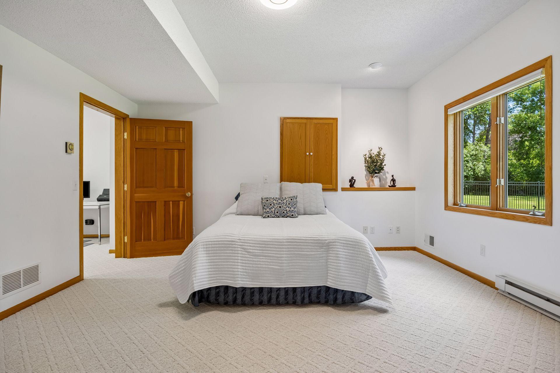 Spacious 5th bedroom in the lower level featuring high ceilings and a private setting