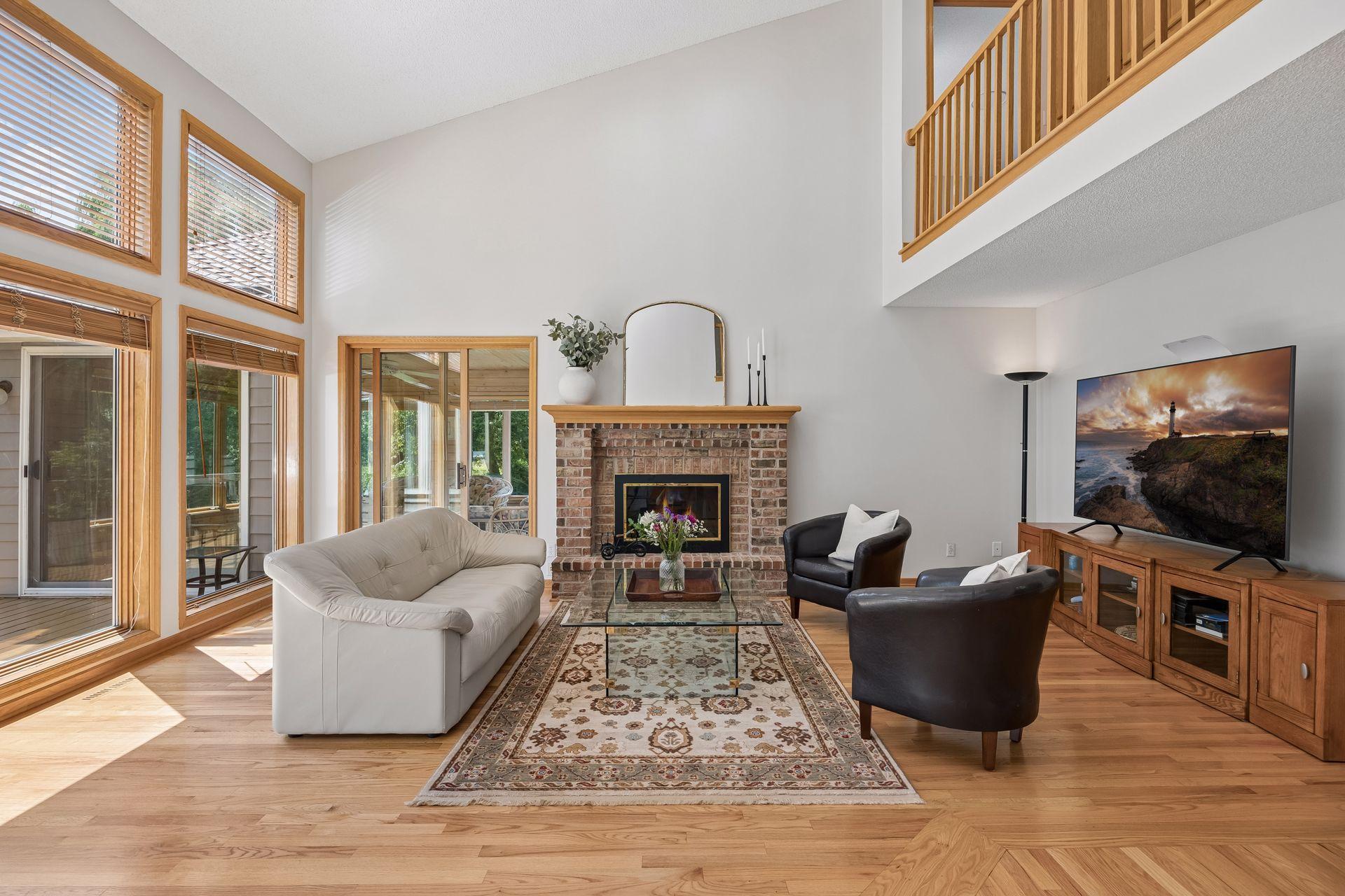 Inviting family room with doors leading to a three-season porch, creating a seamless connection to the private backyard and surrounding natural beauty.