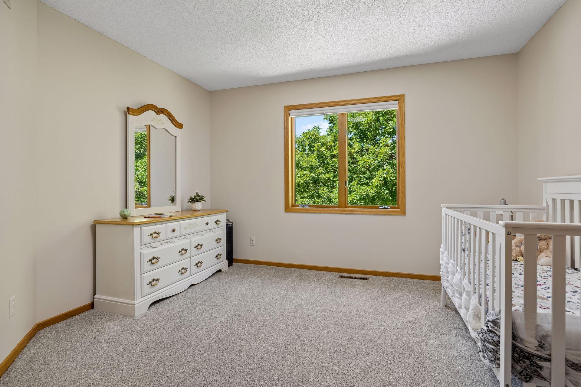 One of four bedrooms on the upper level, offering a spacious layout and plenty of natural light.