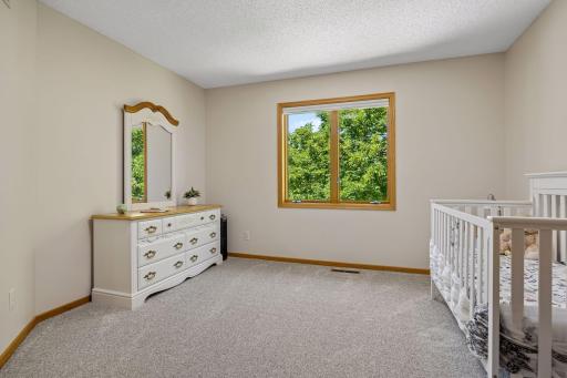 One of four bedrooms on the upper level, offering a spacious layout and plenty of natural light.