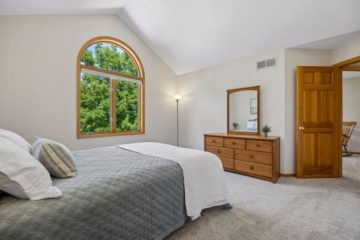 Large bedroom featuring vaulted ceilings, a generous walk-in closet, and abundant natural light for a bright and inviting retreat.