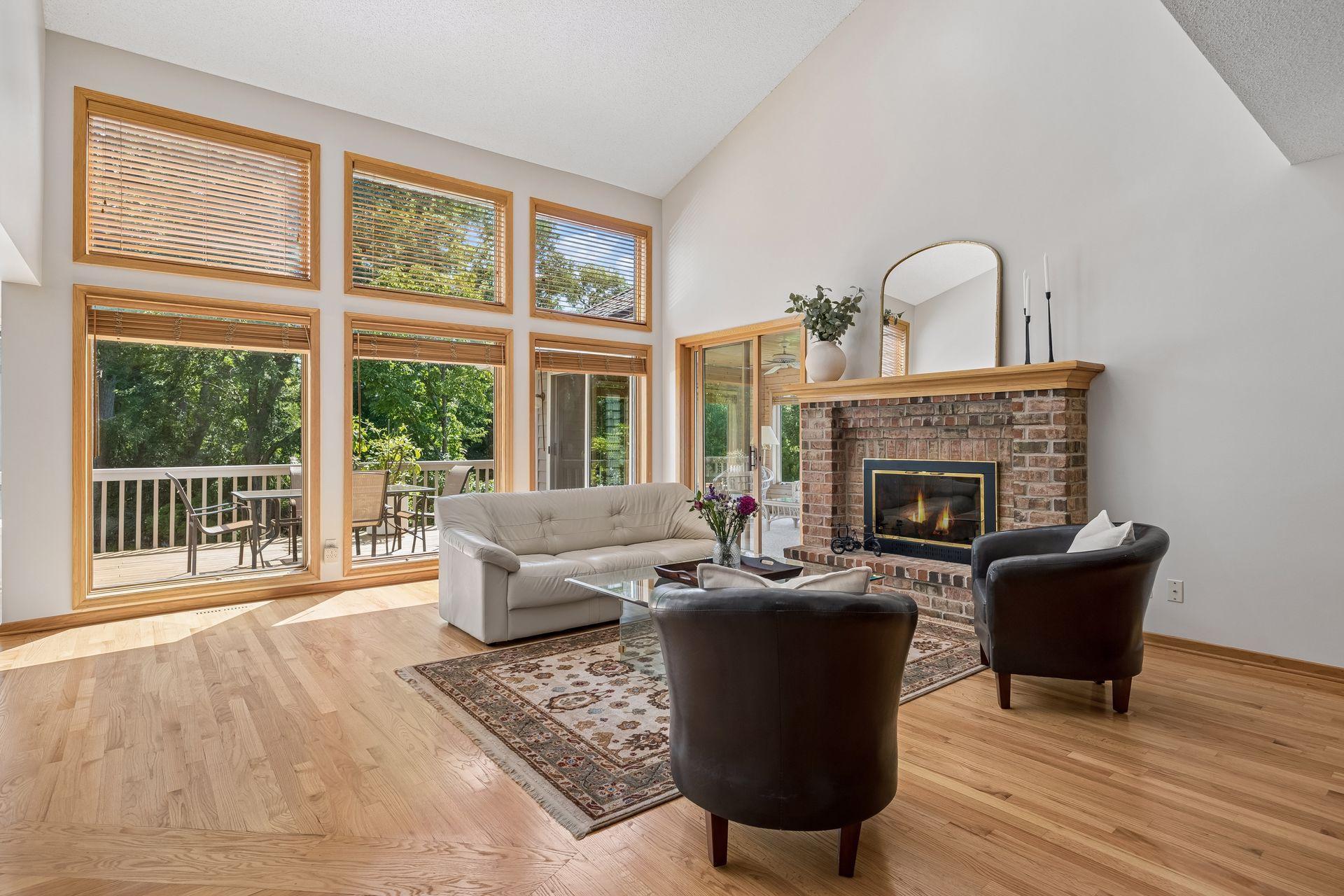 Inviting family room with doors leading to a three-season porch, creating a seamless connection to the private backyard and surrounding natural beauty.