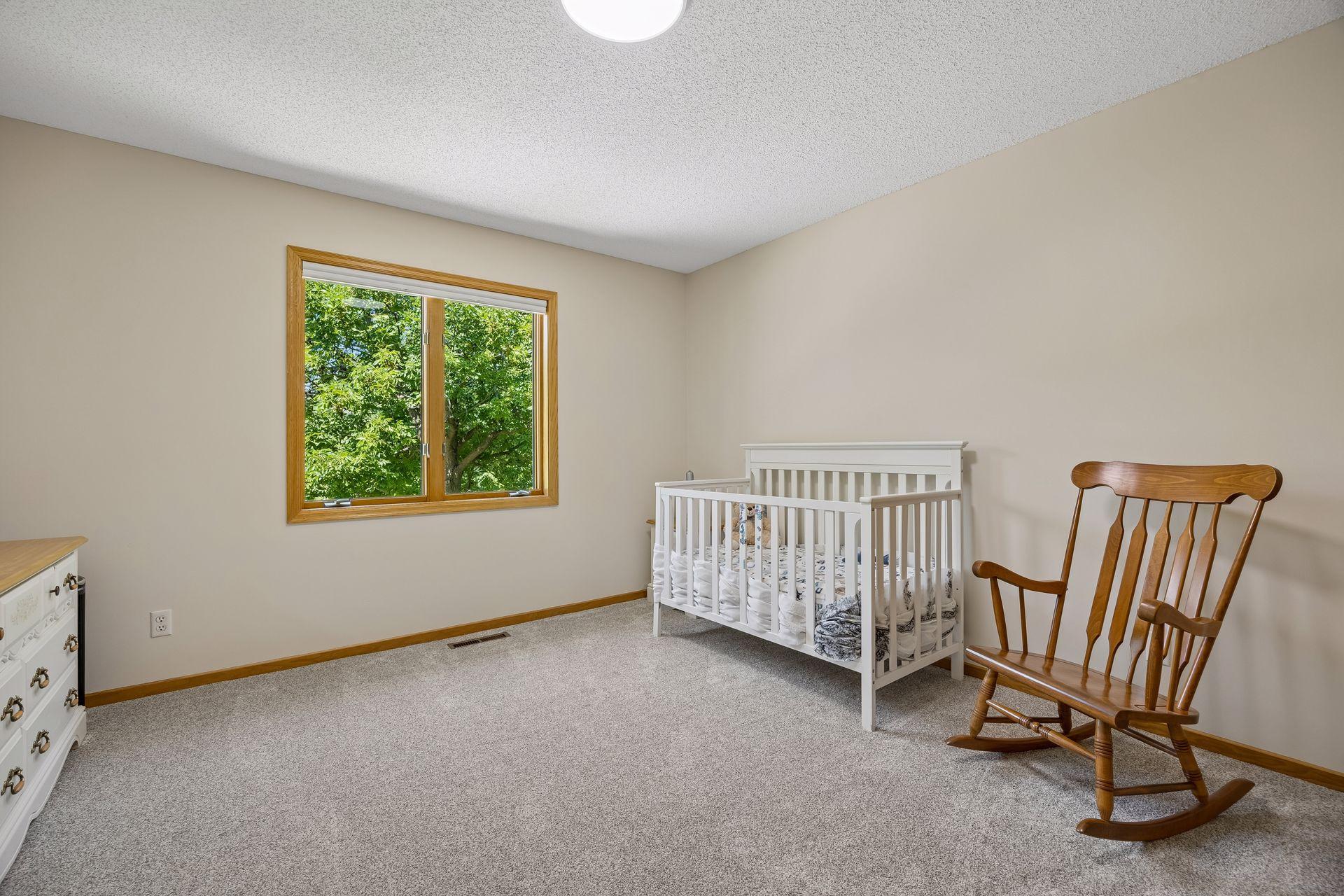 One of four bedrooms on the upper level, offering a spacious layout and plenty of natural light.
