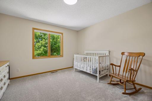 One of four bedrooms on the upper level, offering a spacious layout and plenty of natural light.