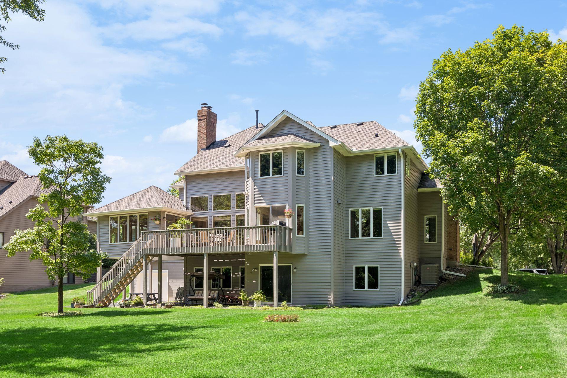 Large, flat, private backyard surrounded by mature trees, offering a peaceful setting with plenty of space for outdoor living, entertaining, and recreation.