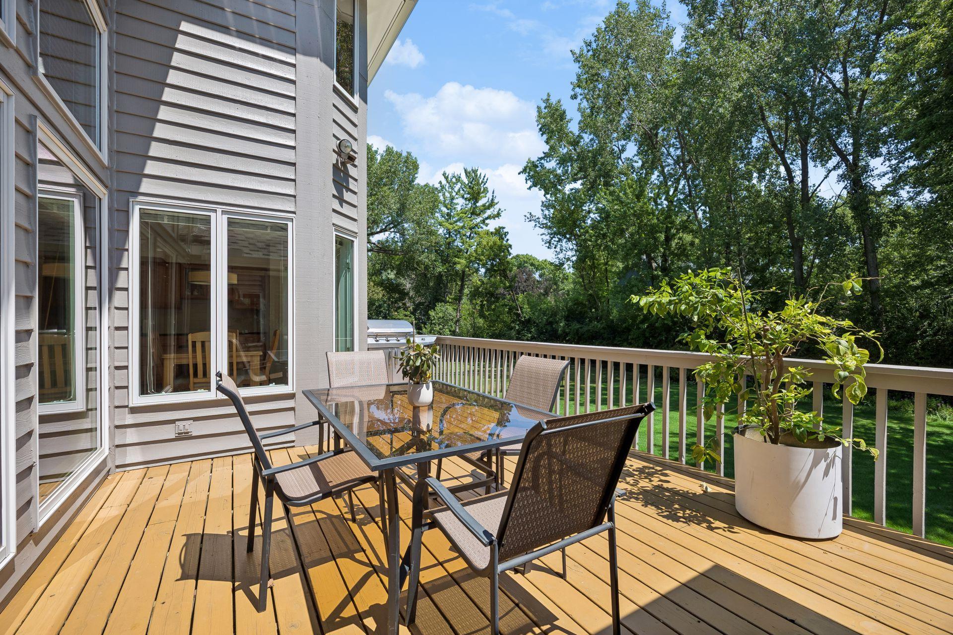 Spacious deck off the back of the home creates a private retreat overlooking the backyard—perfect for relaxing, entertaining, and enjoying the peaceful outdoor setting.