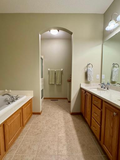 The primary suite continues with two walk in closets and a large bathroom with new quartz counter top and double sinks, soaking tub and separate shower.
