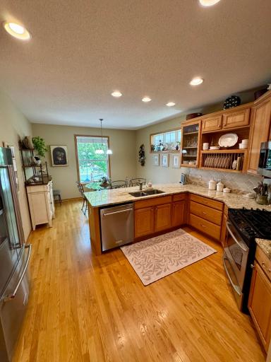 Well-appointed kitchen with granite counter tops, stainless steel appliances, ample cabinetry and workspace.